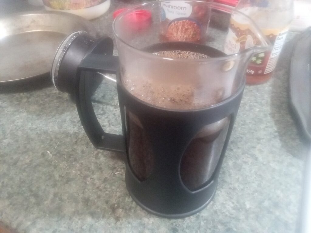 A plunger of freshly brewed coffee